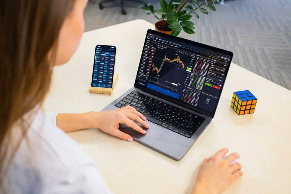 Focused business analysis with charts and graphs on a laptop in a modern office setting.